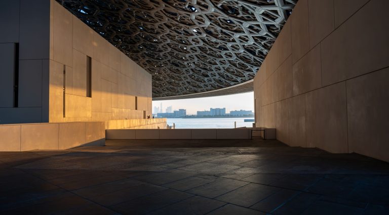 Louvre Abu Dhabi dome at golden hour on Saadiyat Island, the cultural district that Guggenheim Abu Dhabi completes in December 2026