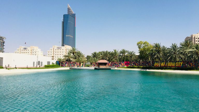 Lagoon and office towers at Dubai Media City, one of the 10 TECOM Group business districts reporting 97% occupancy in H1 2026