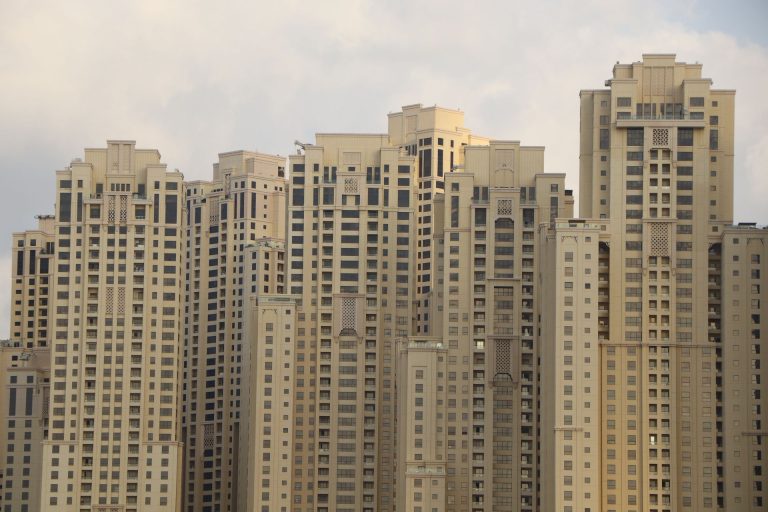 Residential towers of Jumeirah Beach Residence in Dubai, illustrating the UAE rental market moving from post-dated cheques to monthly payments backed by the GCC's first rental guarantee