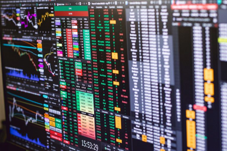 Professional multi-monitor trading terminal with live quotes, charts and order book data, illustrating ADX opening live market data to ChatGPT and Claude