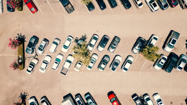 Aerial view of a full sunlit car park, illustrating Parkin Q2 2026 results and the 27% growth of Dubai's paid parking network to 268,300 spaces