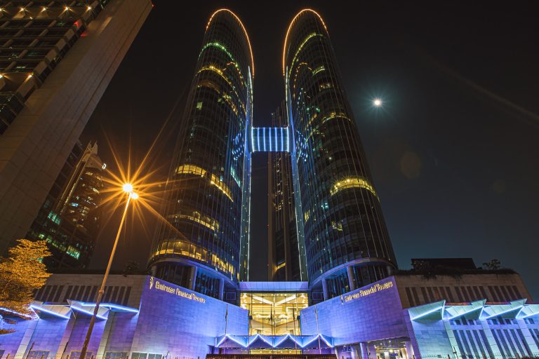 Emirates Financial Towers in Dubai financial district illuminated at night, illustrating UAE bank lending growth of AED 24.7 billion in June 2026