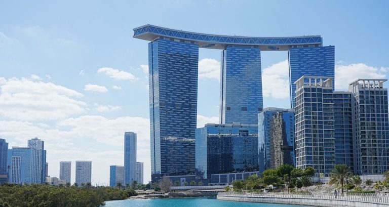 Corporate towers on the Abu Dhabi waterfront, the city where International Holding Company confirmed Fount Trust as the ultimate parent above Royal Group Holding LLC