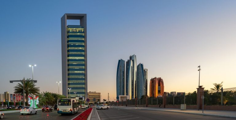 Abu Dhabi business district skyline at dusk with the ADNOC headquarters tower and Etihad Towers, the emirate where EQT opened its first Middle East office in ADGM