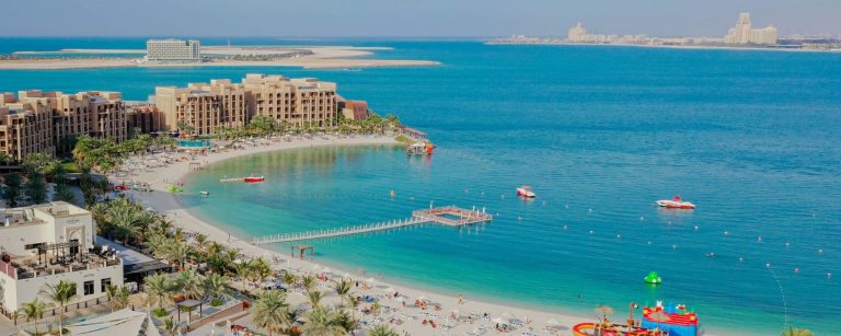 Aerial view of Al Marjan Island in Ras Al Khaimah with beachfront resorts, a lagoon and the sea