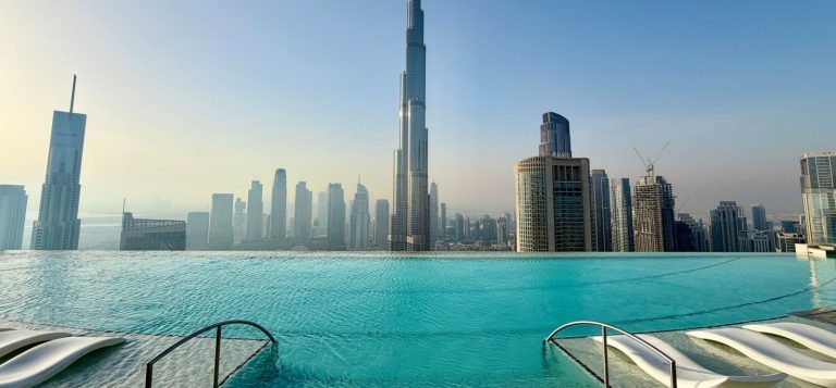 Rooftop hotel infinity pool overlooking the Dubai skyline with the Burj Khalifa and high rise towers