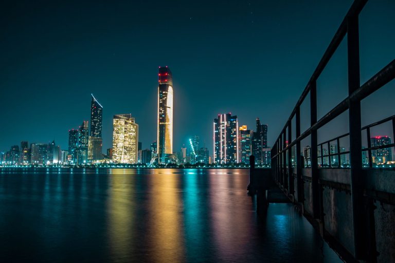 Abu Dhabi skyline at night reflected in the water, illustrating Mubadala and the Abu Dhabi sovereign wealth funds that led Gulf investment in 2026