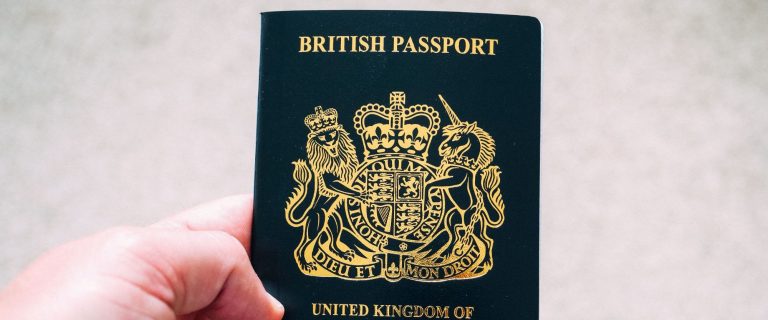British passport held in a hand, illustrating wealthy Britons considering a move from the UK to the UAE