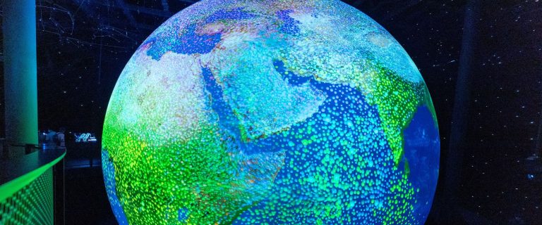 Glowing digital globe with the Arabian Peninsula and the Indian Ocean at the centre, lit in green and blue
