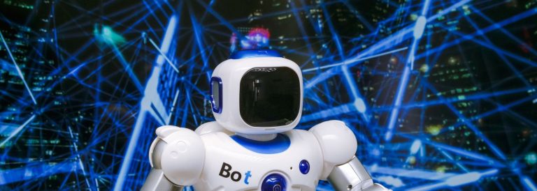 White humanoid robot with blue accents in front of a glowing blue digital network