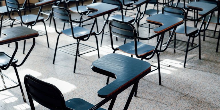 Rows of empty classroom desk chairs in a sunlit room, illustrating new seats in Dubai private schools for the 2026-27 academic year
