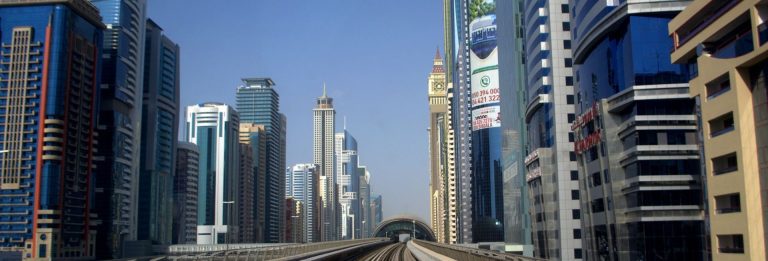 Office and residential towers along Sheikh Zayed Road in Dubai seen from the elevated Dubai Metro track on a clear day