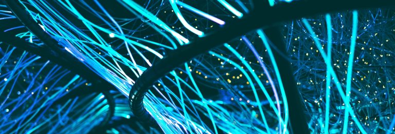 Glowing blue fiber optic strands symbolising international data connectivity