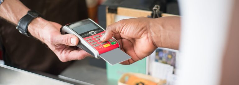 Customer paying with a card at a shop payment terminal, illustrating the Botim Jaywan prepaid card for UAE workers