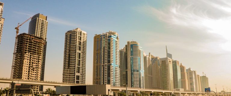 High-rise towers along a Dubai highway under a clear sky, illustrating demand for business space as TECOM Group reports 97% occupancy for 9M 2026